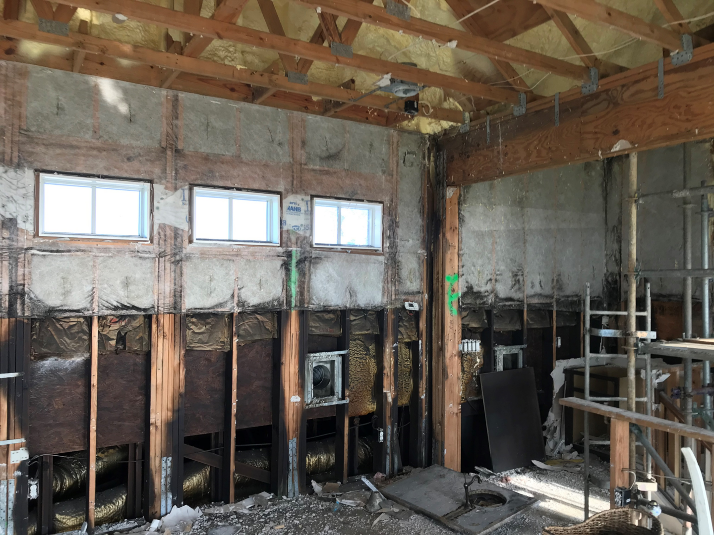 A room that has been demolished and the walls are being torn down.